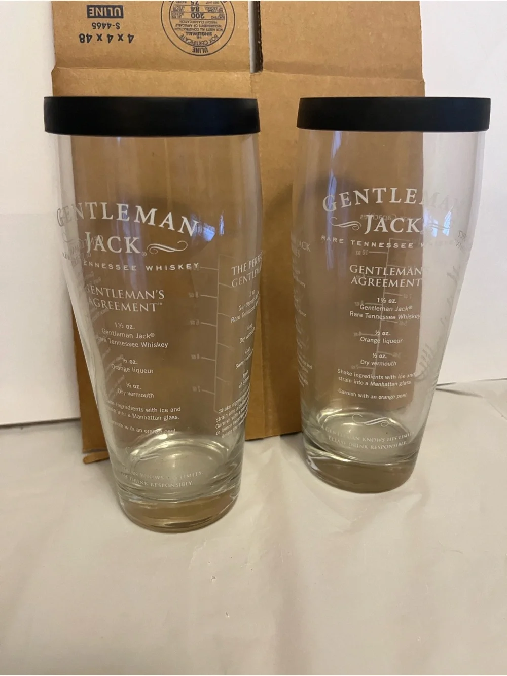2,Gentleman Jack brand glass cocktail shaker with a recipe printed on the side.